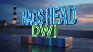 Nags Head DWI lawyer graphic featuring illuminated DWI lettering with an Outer Banks lighthouse at dusk.